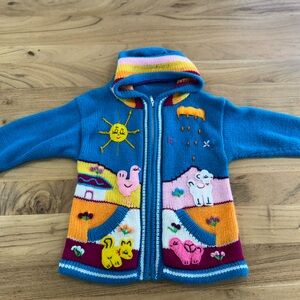 Beautifully hand made sweater with hood, made of wool , warm and elegant